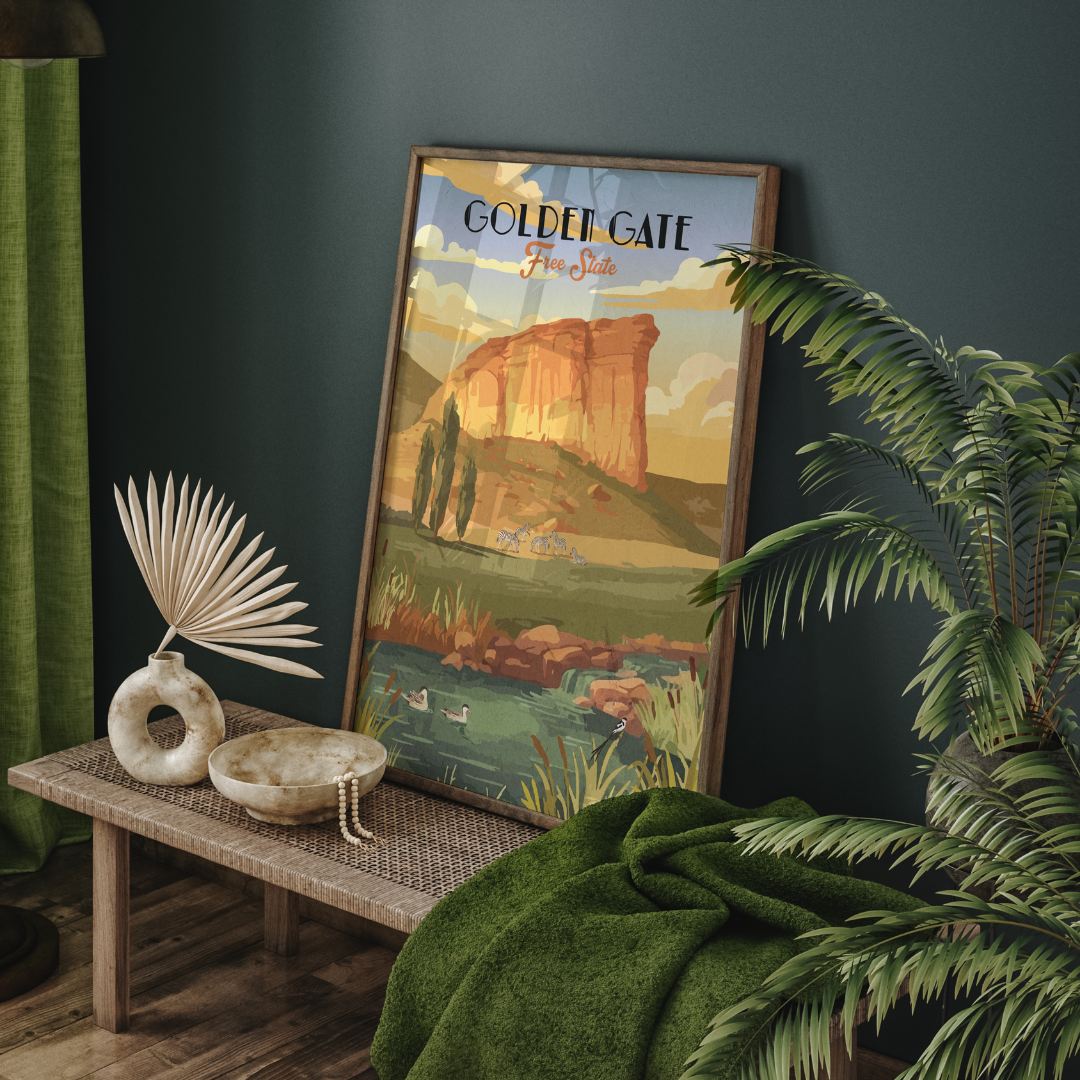 A framed vintage-style travel poster of Golden Gate, leaning on a wooden bench in a styled room with a green throw blanket, potted plant, and decorative bowls.