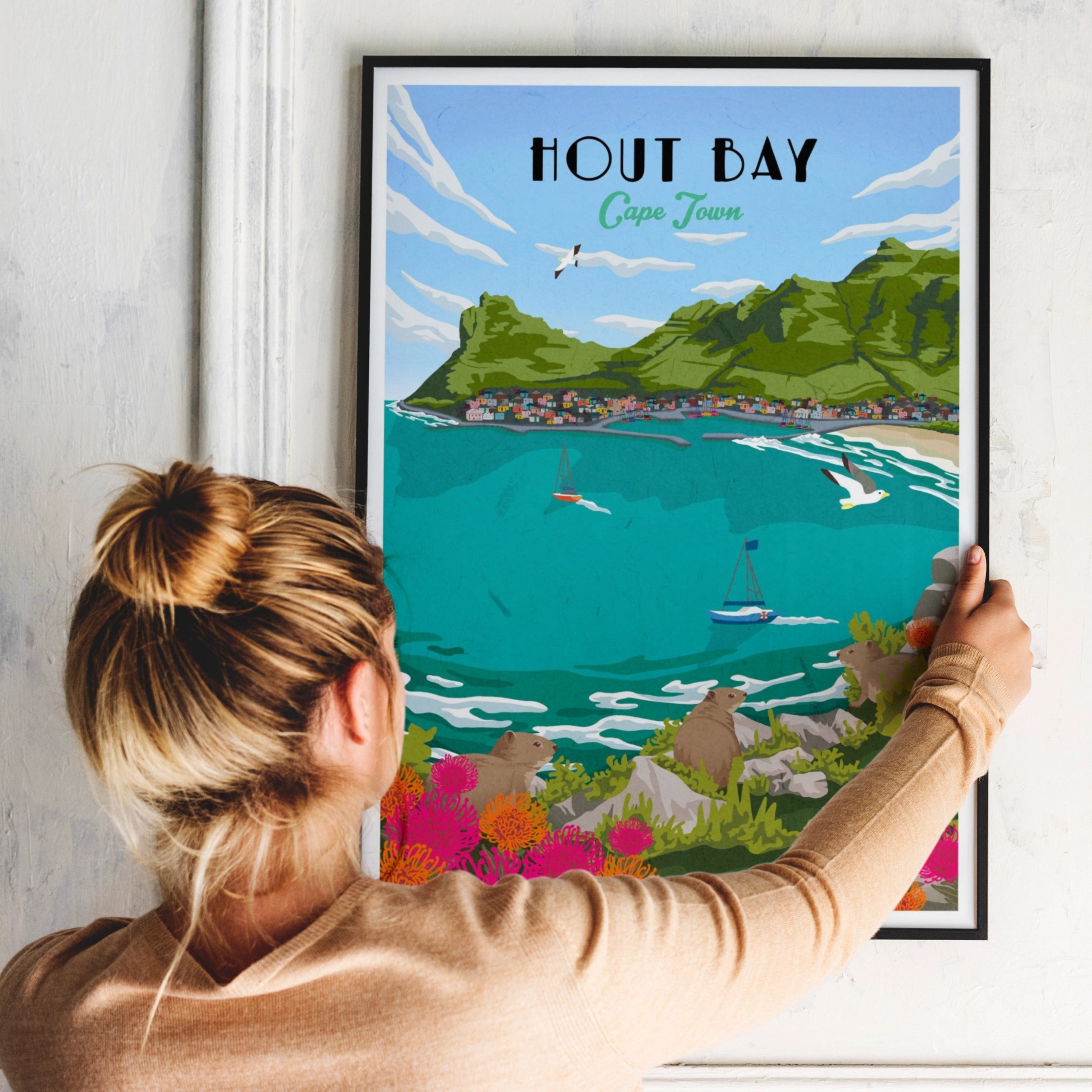 Hout Bay art print – illustrated South African coastal poster featuring mountains and harbour, ideal for wall art and home decor. Framed with a black frame for wall decor