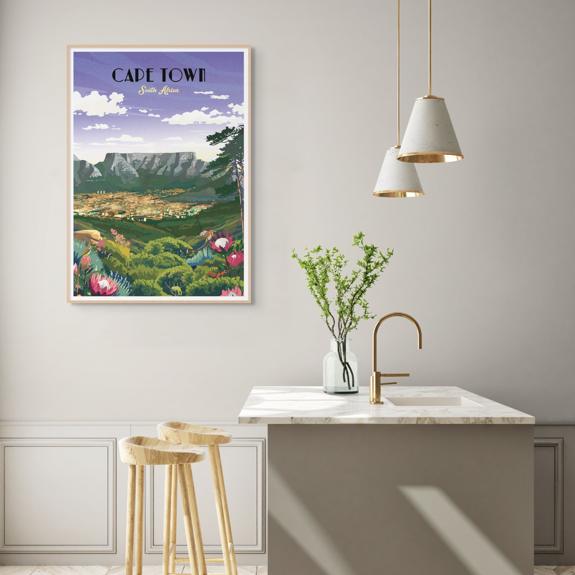 Poster of Cape Town on a wall above a kitchen sink with stools and lights.